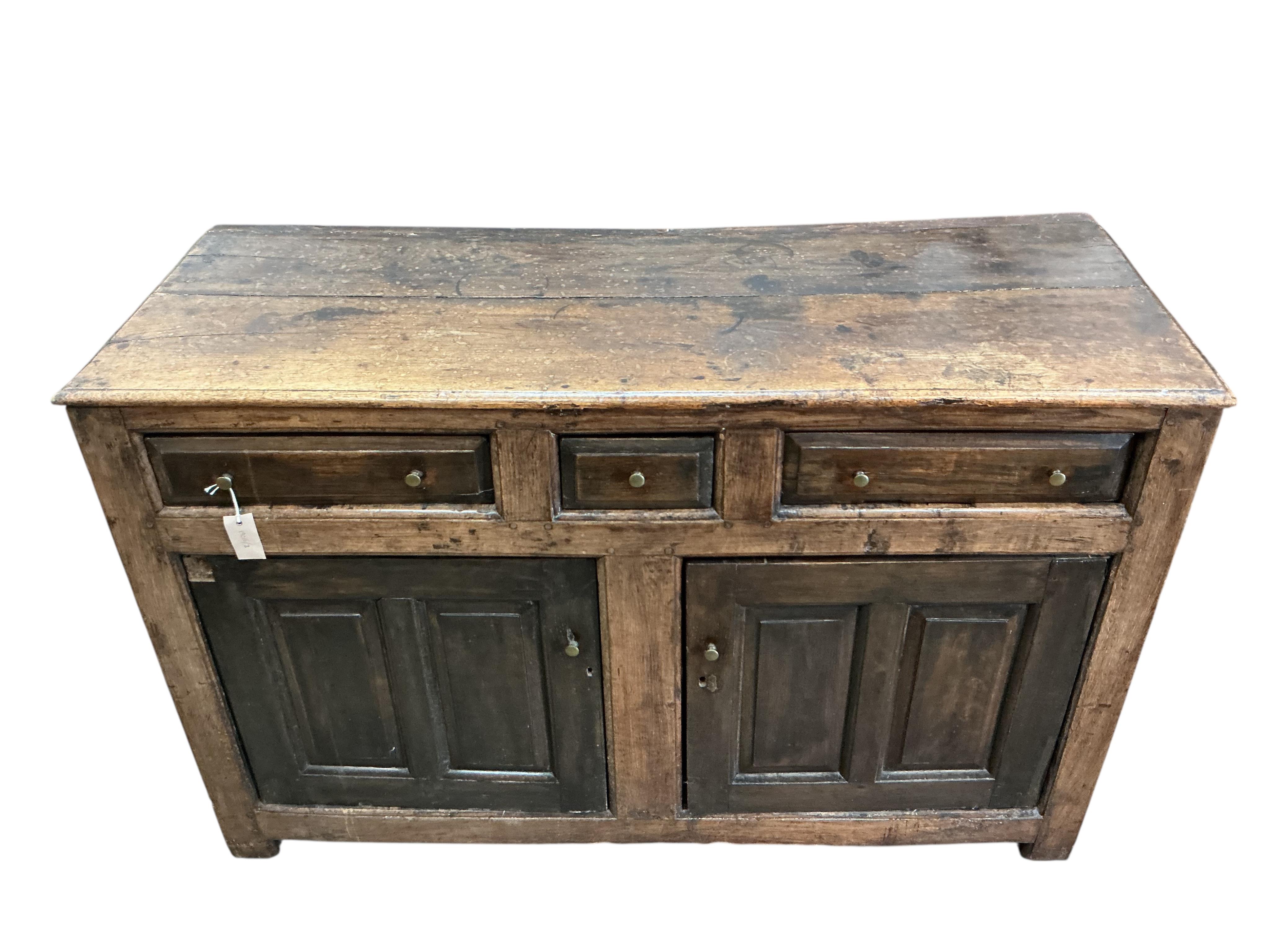 A mid 18th century North Wales oak enclosed dresser base, width 134cm, depth 52cm, height 85cm